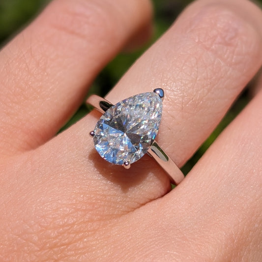 The Beloved Grande — 4CT Pear Cut Moissanite Ring | Heart Detail Band